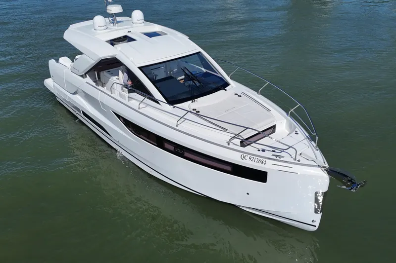  Yacht Photos Pics 2024 Jeanneau DB43 luxury yacht cruising on calm waters.