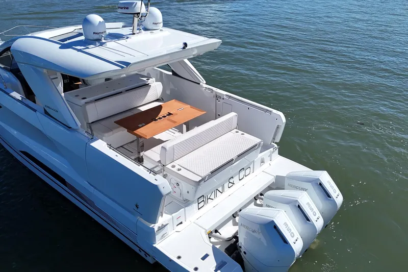  Yacht Photos Pics 2024 Jeanneau DB43 yacht with twin Mercury outboards, featuring a spacious deck and seating area.