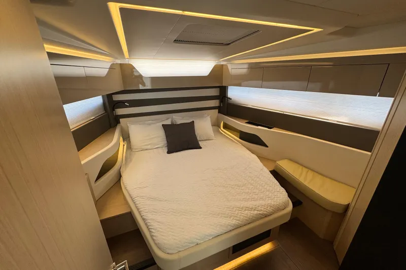  Yacht Photos Pics Luxurious cabin interior of 2024 Jeanneau DB43 yacht with modern lighting and cozy bedding.