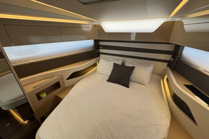  Yacht Photos Pics Luxurious interior cabin of 2024 Jeanneau DB43 yacht with modern design and cozy bedding.