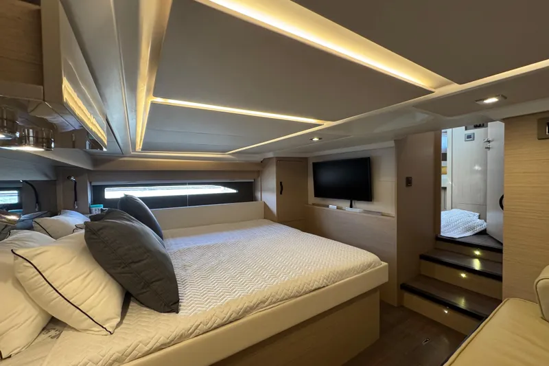  Yacht Photos Pics Luxurious interior of 2024 Jeanneau DB43 yacht with modern bedroom and ambient lighting.