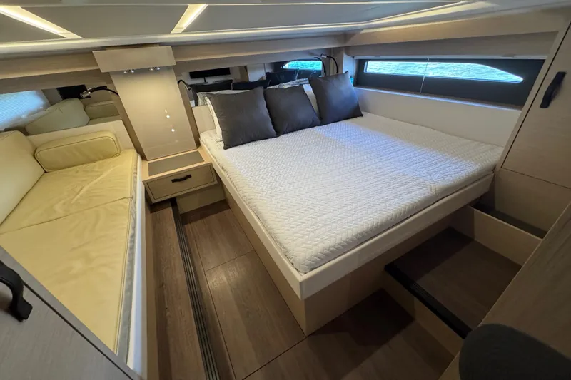  Yacht Photos Pics 2024 Jeanneau DB43 cabin interior with bed, sofa, and modern design.