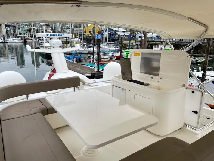  Yacht Photos Pics Luxurious 2014 Ferretti Yachts 690 with elegant outdoor seating and dining area.