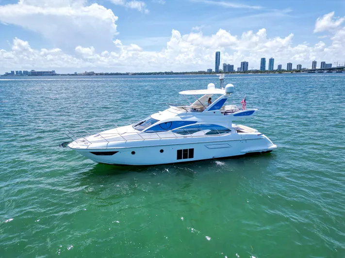  Yacht Photos Pics 2015 Azimut 54 Fly yacht cruising on clear blue water under a sunny sky.