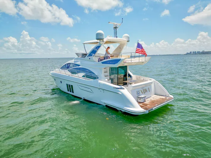  Yacht Photos Pics Azimut 54 Fly 2015 yacht cruising on open water under a clear blue sky.