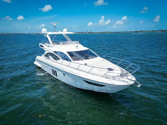  Yacht Photos Pics 2015 Azimut 54 Fly yacht cruising on open water under clear blue skies.