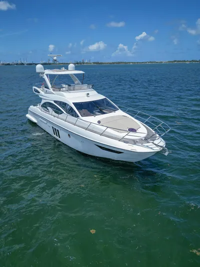  Yacht Photos Pics 2015 Azimut 54 Fly yacht cruising on clear blue waters under a sunny sky.