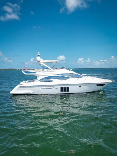  Yacht Photos Pics 2015 Azimut 54 Fly yacht cruising on clear blue waters under a sunny sky.