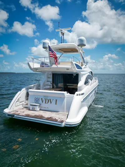  Yacht Photos Pics Azimut 54 Fly 2015 yacht cruising on open water under a clear blue sky.