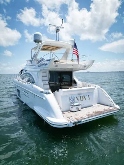  Yacht Photos Pics Azimut 54 Fly 2015 yacht on water, rear view with American flag, clear sky.