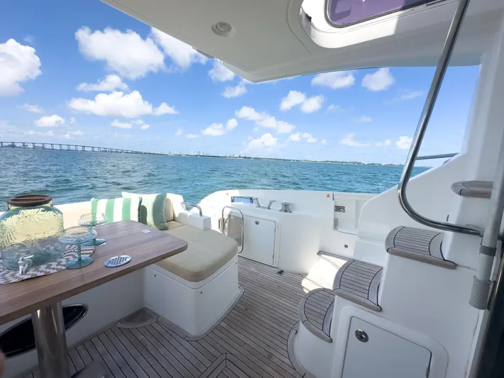  Yacht Photos Pics Azimut 54 Fly 2015 yacht deck with ocean view, featuring seating and table setup.