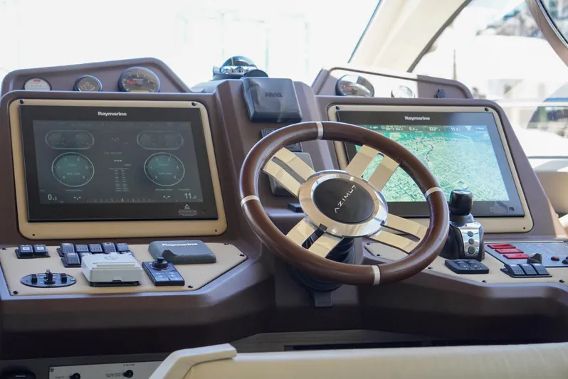  Yacht Photos Pics Cockpit of 2015 Azimut 54 Fly yacht with Raymarine navigation displays and steering wheel.