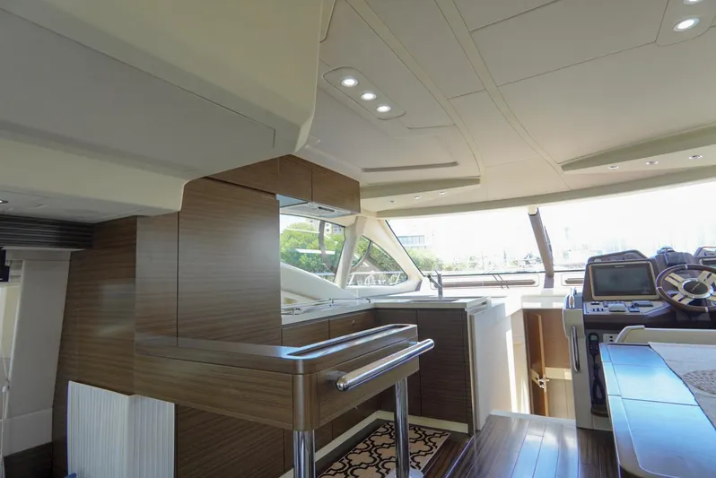  Yacht Photos Pics Luxurious interior of 2015 Azimut 54 Fly yacht with modern helm and sleek wood finishes.