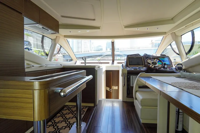  Yacht Photos Pics Luxurious interior of 2015 Azimut 54 Fly yacht with modern helm and elegant wood finishes.
