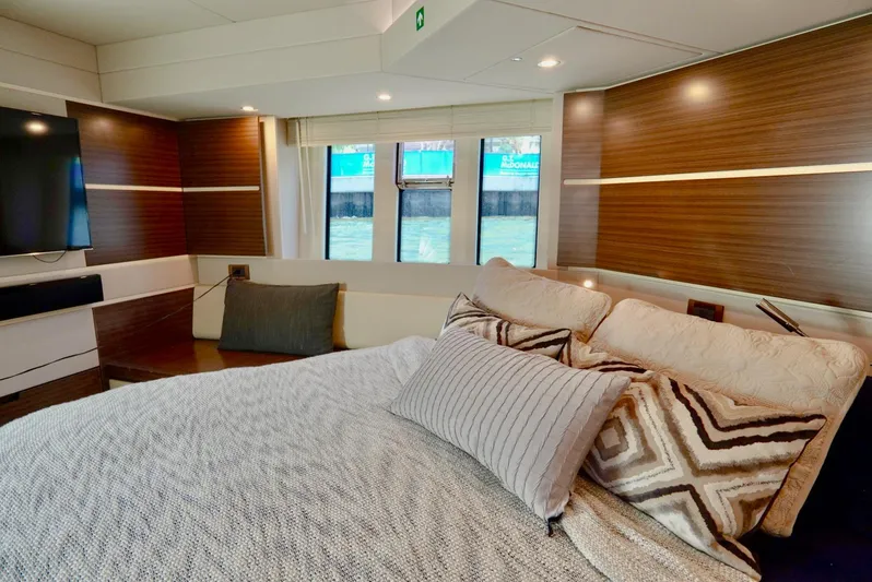  Yacht Photos Pics Luxurious bedroom interior of 2015 Azimut 54 Fly yacht with modern decor and large windows.