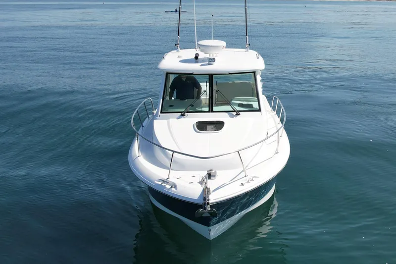 Strike Zone Yacht Photos Pics 2018 Boston Whaler 315 Conquest boat on calm water, front view.