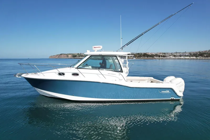 Strike Zone Yacht Photos Pics 2018 Boston Whaler 315 Conquest boat on calm ocean waters.