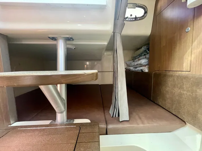Strike Zone Yacht Photos Pics 2018 Boston Whaler 315 Conquest cabin interior with seating and wooden finishes.
