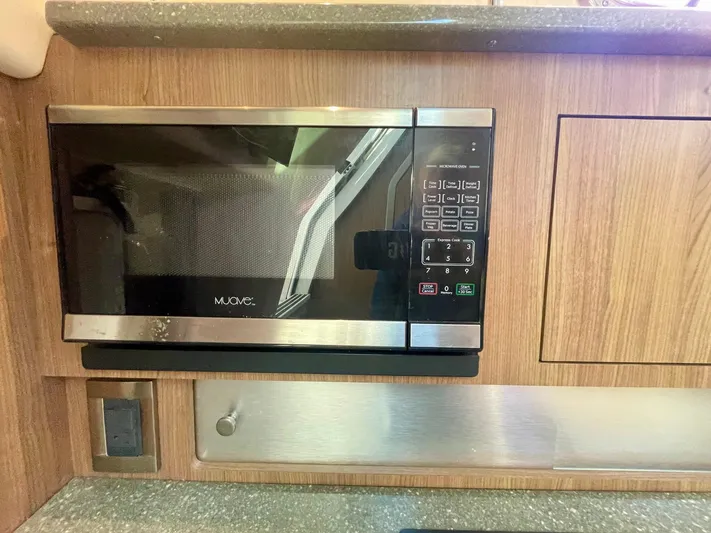 Strike Zone Yacht Photos Pics Microwave in 2018 Boston Whaler 315 Conquest boat kitchen, wood paneling, and countertop.