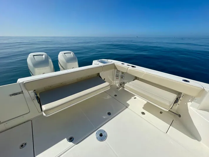 Strike Zone Yacht Photos Pics 2018 Boston Whaler 315 Conquest boat deck with twin engines on calm sea.