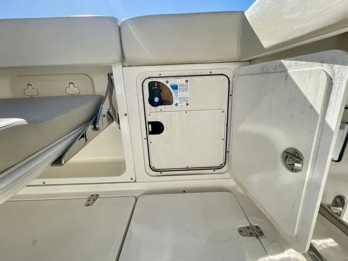 Strike Zone Yacht Photos Pics 2018 Boston Whaler 315 Conquest interior storage compartment with open hatch.