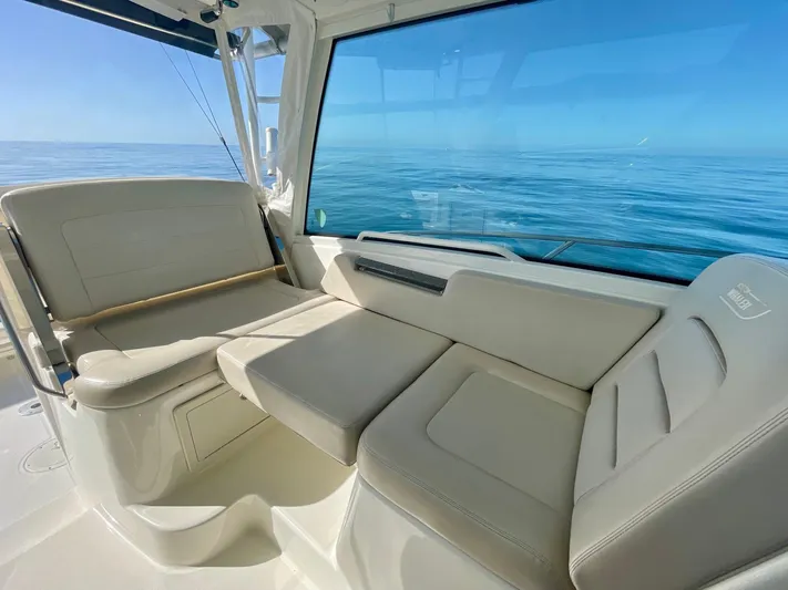 Strike Zone Yacht Photos Pics 2018 Boston Whaler 315 Conquest interior with beige seating, ocean view.