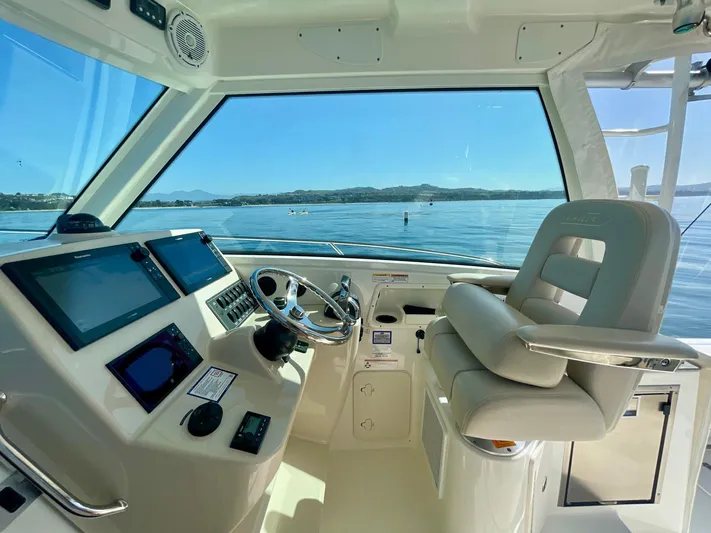 Strike Zone Yacht Photos Pics 2018 Boston Whaler 315 Conquest helm with modern controls and scenic ocean view.