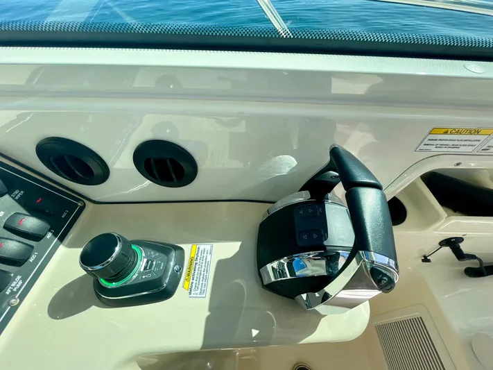 Strike Zone Yacht Photos Pics Control panel of a 2018 Boston Whaler 315 Conquest boat, featuring throttle and joystick.