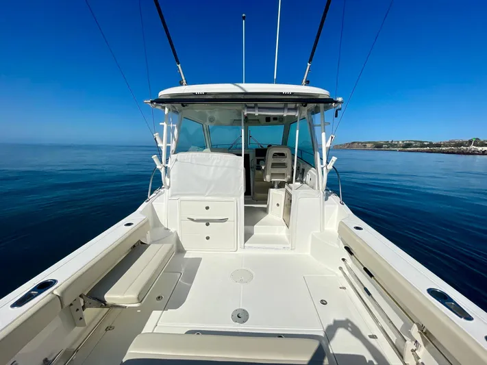 Strike Zone Yacht Photos Pics 2018 Boston Whaler 315 Conquest boat on calm water, showcasing spacious deck and seating.