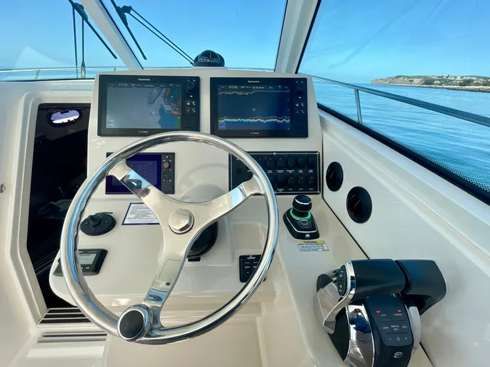 Strike Zone Yacht Photos Pics Helm of 2018 Boston Whaler 315 Conquest with navigation screens and controls.