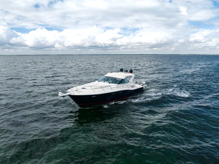 Gabriella Yacht Photos Pics Uniesse 48 Open 2001 yacht cruising on open sea under cloudy sky.