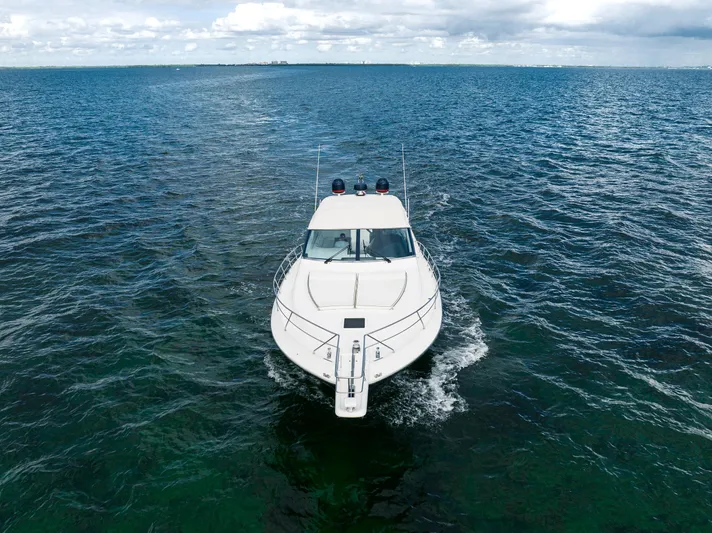 Gabriella Yacht Photos Pics Uniesse 48 Open 2001 yacht cruising on open sea under cloudy sky.