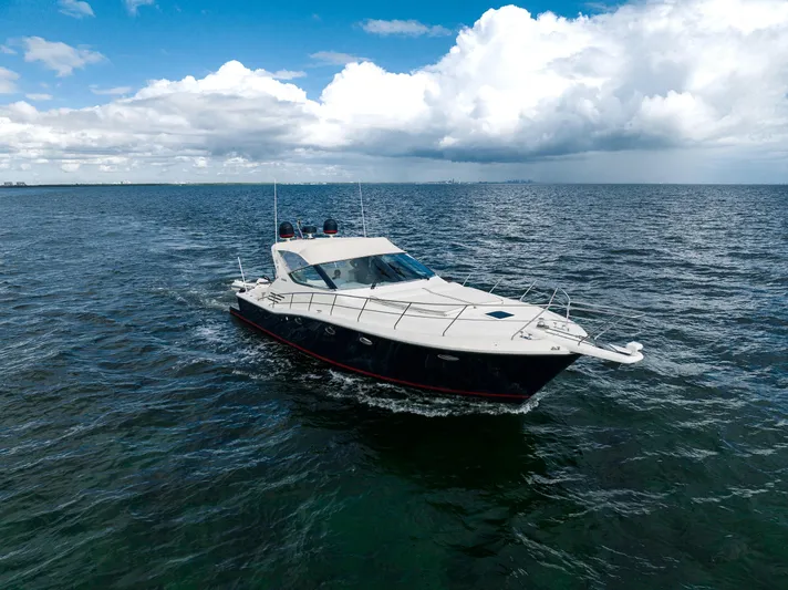 Gabriella Yacht Photos Pics Uniesse 48 Open 2001 yacht cruising on open sea under cloudy sky.