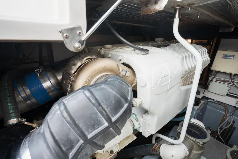 Gabriella Yacht Photos Pics Engine compartment of 2001 Uniesse 48 Open yacht, showcasing mechanical components and piping.