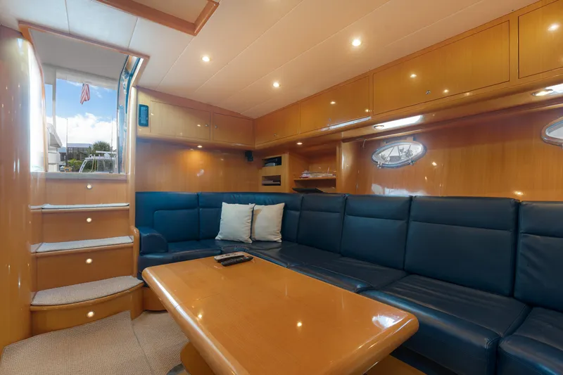 Gabriella Yacht Photos Pics Luxurious interior of 2001 Uniesse 48 Open yacht with blue seating and wooden accents.