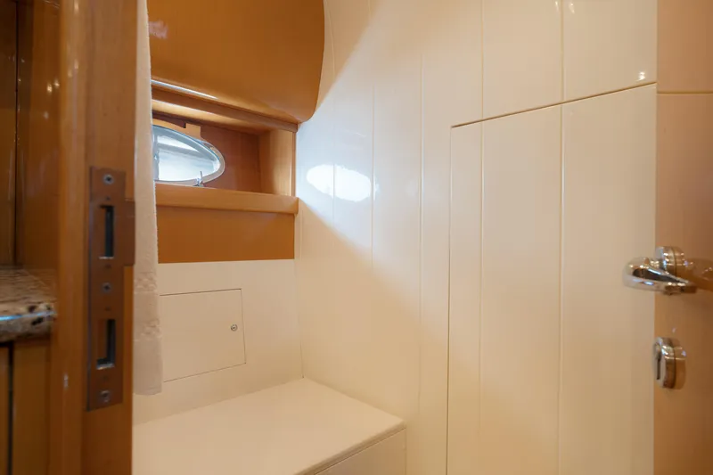 Gabriella Yacht Photos Pics Interior of 2001 Uniesse 48 Open yacht bathroom with porthole and wooden accents.