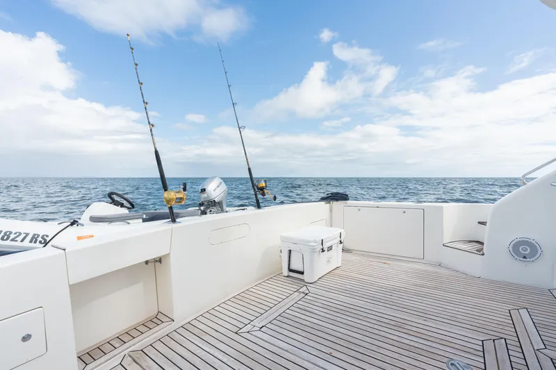 Gabriella Yacht Photos Pics Uniesse 48 Open 2001 yacht deck with fishing rods and ocean view.