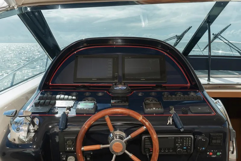 Gabriella Yacht Photos Pics Uniesse 48 Open 2001 yacht helm with wooden steering wheel and navigation screens.