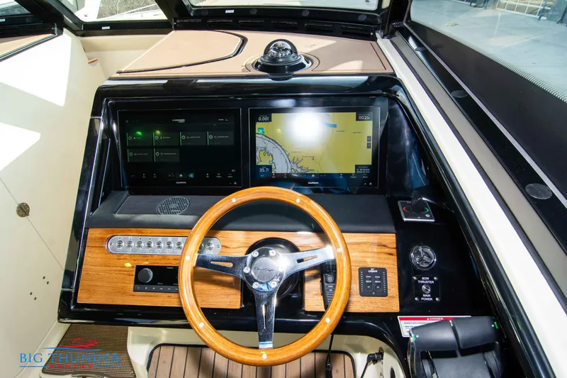  Yacht Photos Pics 2024 Chris-Craft CALYPSO 35 CP dashboard with wooden steering wheel and dual navigation screens.