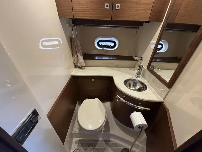  Yacht Photos Pics Luxurious bathroom in 2013 Sea Ray 470 Sundancer yacht with modern fixtures and wood accents.