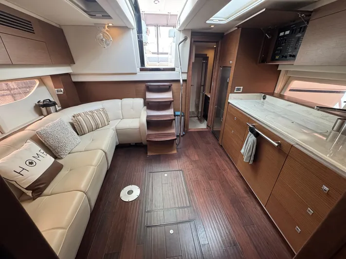  Yacht Photos Pics Luxurious interior of 2013 Sea Ray 470 Sundancer yacht with modern kitchen and cozy seating area.