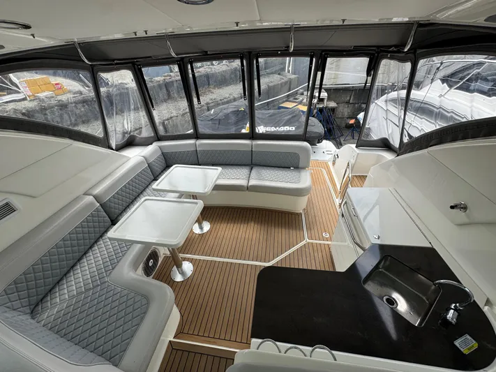  Yacht Photos Pics Luxurious interior of 2013 Sea Ray 470 Sundancer yacht with elegant seating and tables.