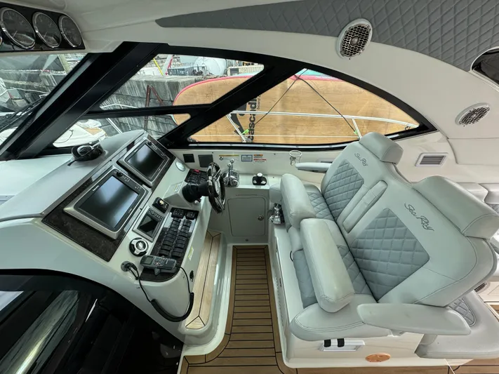  Yacht Photos Pics Luxurious cockpit of 2013 Sea Ray 470 Sundancer with modern controls and plush seating.