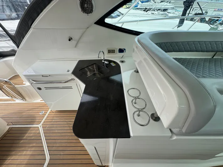 Yacht Photos Pics Luxurious interior of 2013 Sea Ray 470 Sundancer with sleek countertop and seating.