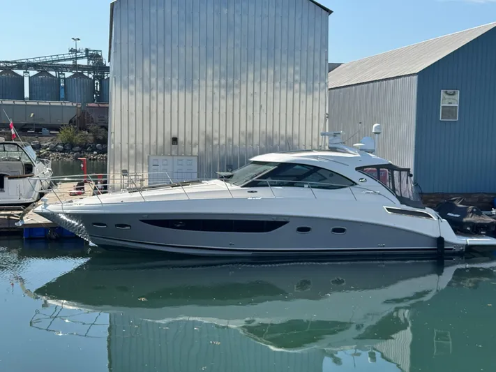  Yacht Photos Pics 2013 Sea Ray 470 Sundancer yacht docked at marina, reflecting on calm water.