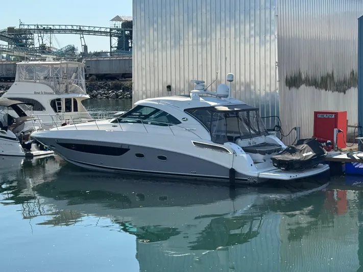  Yacht Photos Pics 2013 Sea Ray 470 Sundancer yacht docked at marina, reflecting on calm water.
