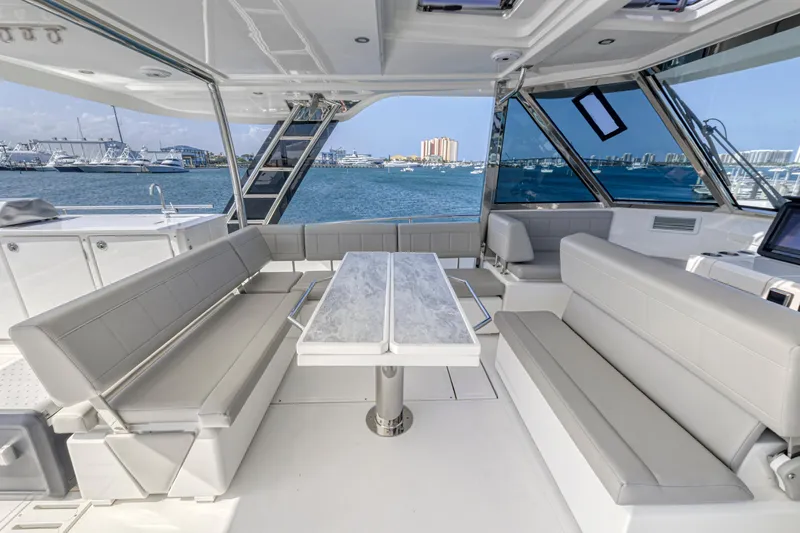  Yacht Photos Pics Luxurious 2023 Aquila 54 Yacht interior with elegant seating and ocean view.
