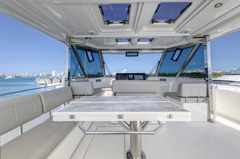  Yacht Photos Pics Luxurious interior of 2023 Aquila 54 Yacht with panoramic windows and elegant seating.