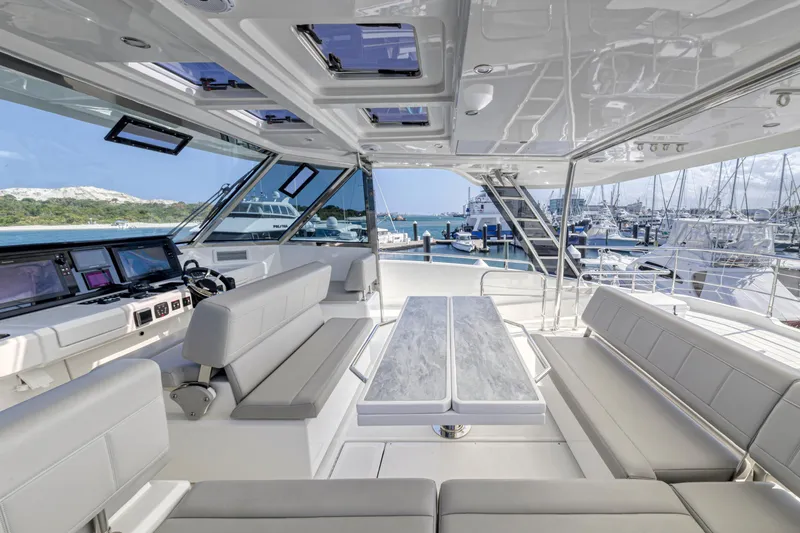  Yacht Photos Pics Luxurious 2023 Aquila 54 Yacht interior with modern seating and panoramic views.
