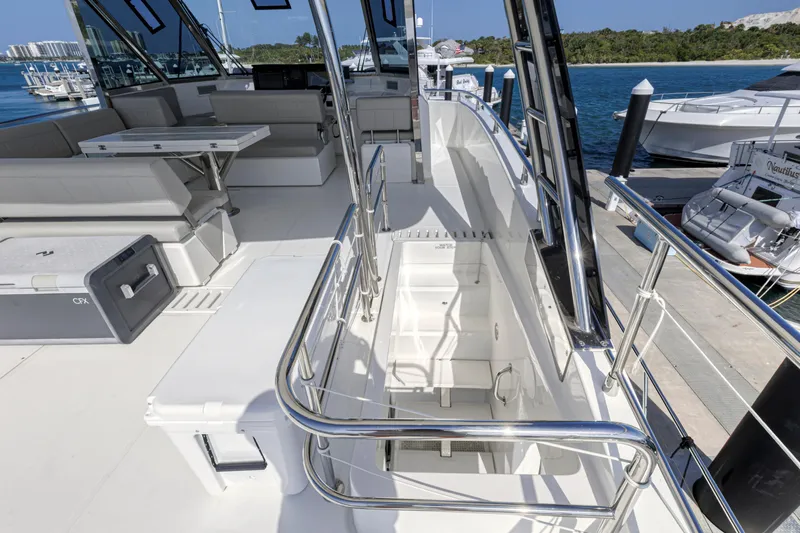  Yacht Photos Pics 2023 Aquila 54 Yacht deck with seating, table, and ocean view.